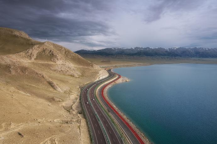 road near body of water during daytime